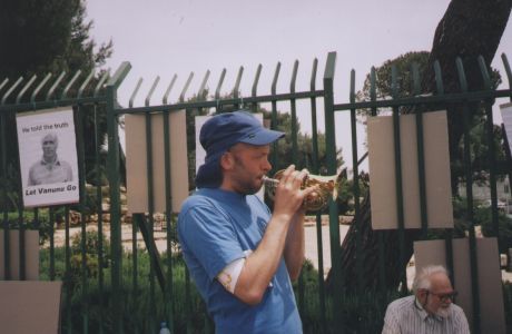 Ben on trumpet, penned in, across the road from Knesset