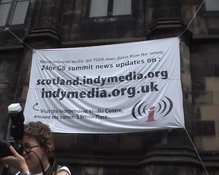 Indymedia banner hanging off the Church near Bristo Place