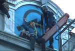 riot cops in cherry picker pluck defender of space from Miles roof