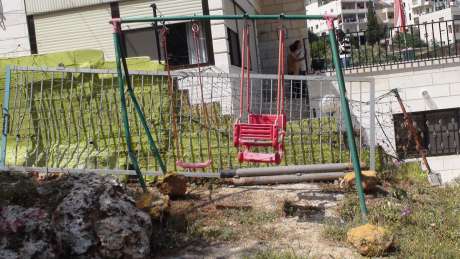 Bulldozed in prepartion for a new section of the Apartheid-Annexation Wall, remnant of play area that Mitri Ghneim provided for his four children in Beit Jala 
