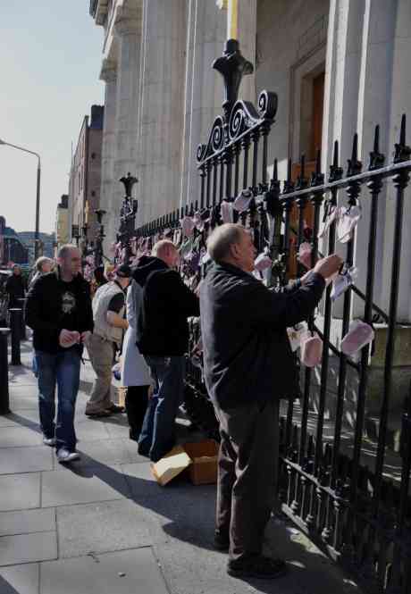 Protesters tying shoes to railings at the Pro Cathedral