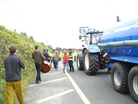 The band continue to play as the tractor moves