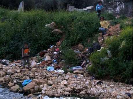 Palestinian children play in a polluted stream contaminated by wastewater from Ariel settlement, Bruqin, West Bank. (Photo: EWASH-OPT)