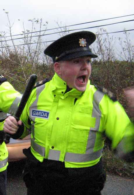 Irish police officer during an attack on peaceful protest against Shell refinery construction