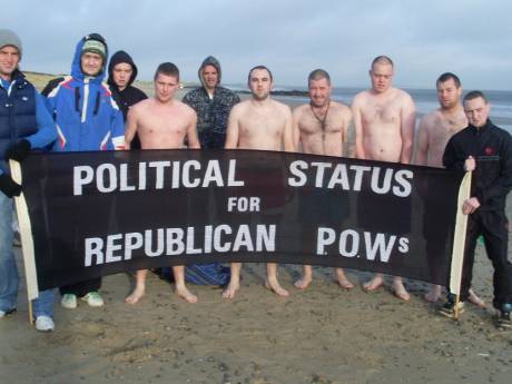 CABHAIR Swim , Wexford - 25/12/2011 . Five swimmers seek shelter behind a banner.....!