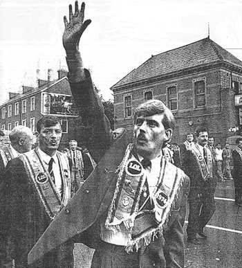 From The Independent 11 July 1997: Triumphalism: Ormeau Road 1992, an Orangeman holds up five fingers as a parade passes a spot where five Catholics were shot dead by loyalist terrorists.