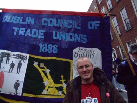 DCTU banner with added smiling protestor
