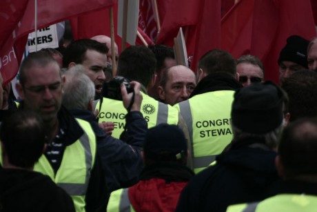 Stewards try to block Waterford Glass workers and union officials from standing in front of speakers platform...