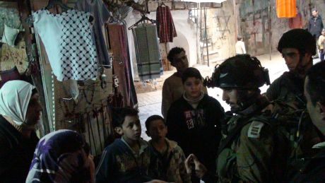 IOF officer investigating colonist's spitting