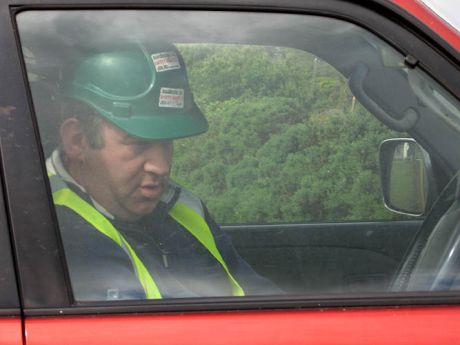A shell contractor with a radio observed the protests from a jeep protected by Garda