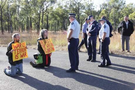 Queensland Police prepare to arrest peace activists Jim Dowling & Ciaron O Reilly for blocking military vehicles access to the Talisman Sabre military training facility.