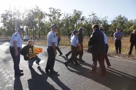Police arresting Anti-War activists Jim Dowling and Ciaron O Reilly for blocking military access to the Talisman Sabre training facility