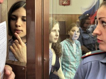 Members of the Pussy Riot punk band (from left in the background) Nadezhda Tolokonnikova, Maria Alyokhina and Yekaterina Samutsevich during the hearings on the merits on their case in Moscow's Hamovniki Court (RIA Novosti/Andrey Stenin)