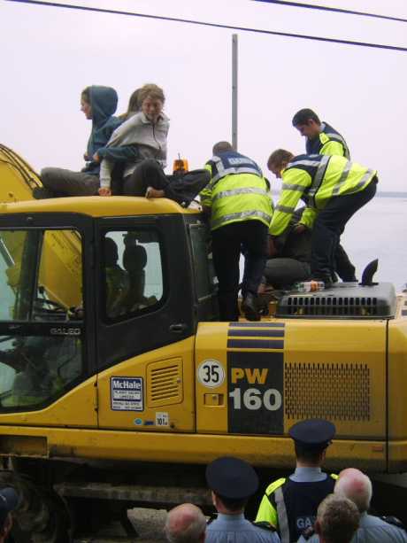Gardai attempt to remove protesters from the digger. 