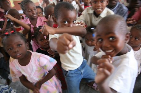 Children from Wharf Jeremie, a slum built on a rubbish dump in Port-au-Prince, at one of the few primary educational facilities available, meals are guaranteed.