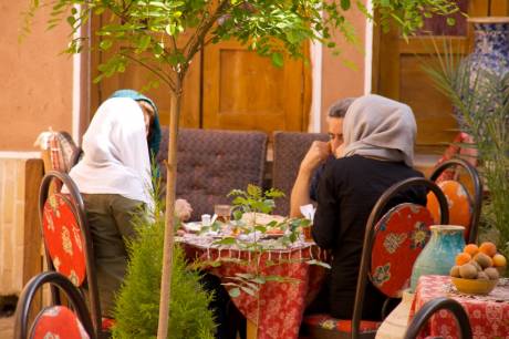 Man and two women in the traditional restaurant in the city of Yazd