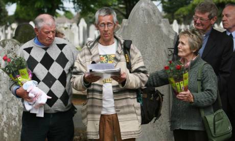 Former Bethany Home residents Derek Leinster, Patrick Anderson McQuoid and Noleen Belton attend a memorial service at the unmarked graves of 40 children from the home in Mount Jerome cemetery in Dublin 