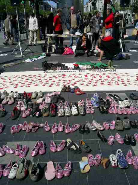 Children's shoes were placed in front of a memorial banner to remember the children of Palestine