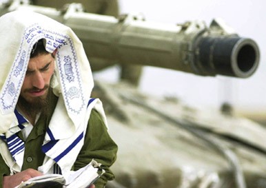 Peaceful Jewish Chap praying to his "God" while sitting on his Fully armed and dangerous Merkava Tank