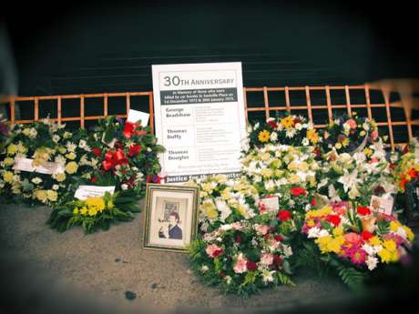 Wreaths and a picture of Tommy Douglas left at the 30th anniversary of the bombings at Sackville Place