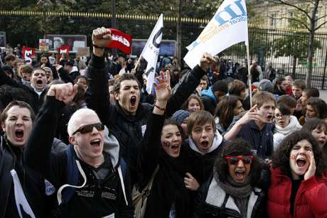 Students shout slogans as they demonstrate with union workers in Paris against raising the retirement age to 62